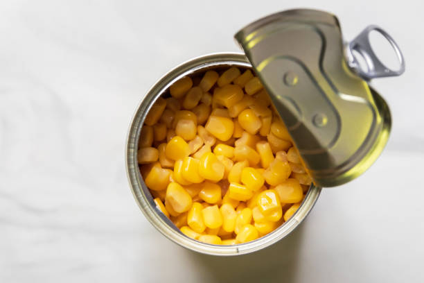 istock Sweet corn in can look delicious. Top view on marble background. 1341237922