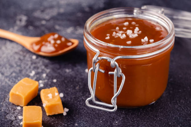 Glass jar with tasty delicious salted caramel stock photo