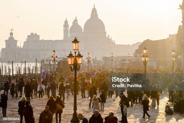 Crowd Of Tourists At The Carnival In St Marks Square In The Background The Basilica Of Santa Maria Della Salutevenice Italy Europe Stock Photo - Download Image Now