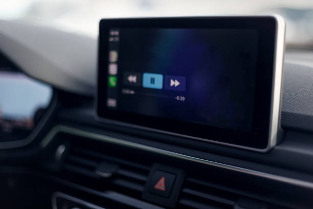 istock Car multimedia system. Glowing beautiful dashboard of a modern expensive car. The interior of the car. The foreground is blurred. Modern car interior details. Selective focus 1341245000