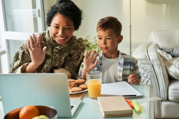 istock Black mother and son having video call on laptop 1341245642