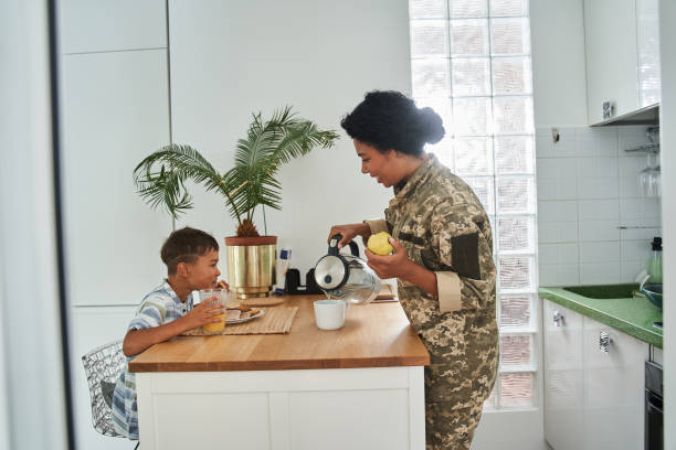 istock Woman pouring tea while having breakfast together with her lovely son 1341245706