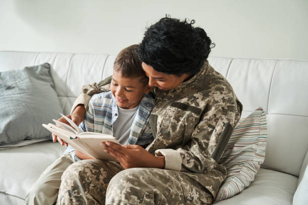 istock Multiracial woman wearing uniform reading book while sitting at the sofa 1341247208