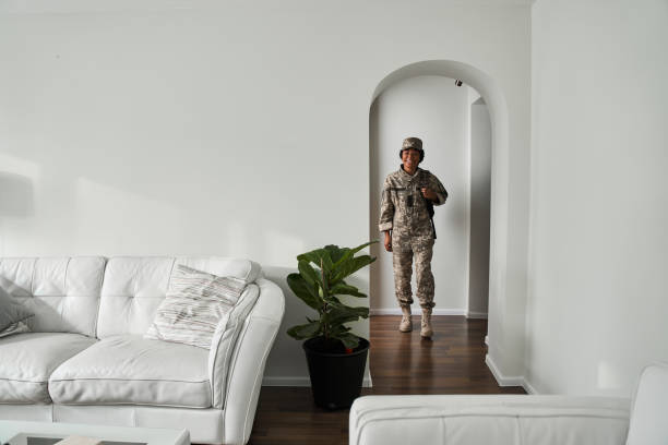 istock Black female soldier coming back home from army 1341247221