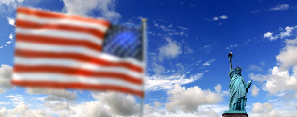 istock Statue of Liberty and American flag 1341248200