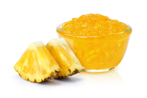 Pineapple jam white background. Pineapple jam in glass bowl and fresh pineapple fruit isolated on white background. marmalade stock pictures, royalty-free photos & images