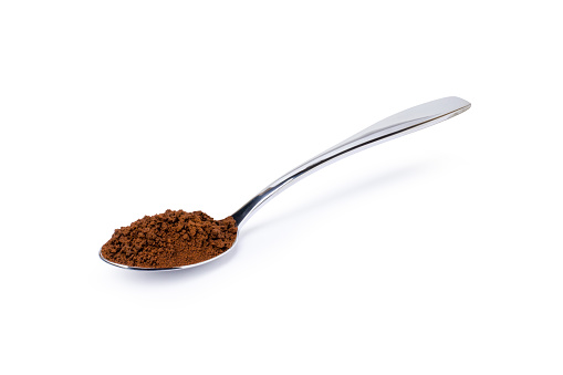 Instant coffee powder in stainless teaspoon isolated on white background. Clipping path.