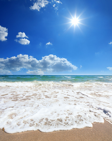 Seascape view with waves and sandy beach over sky in Boca Raton, Florida