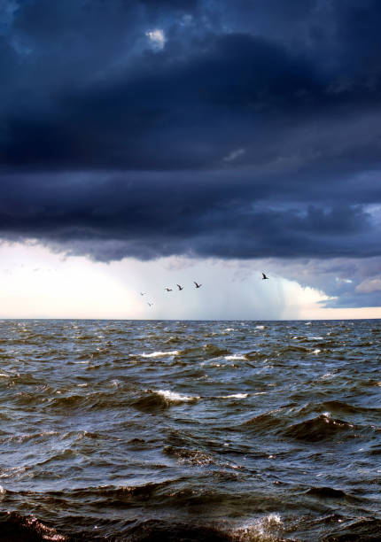 Dramatic storm cell system over ocean illuminated by sunset. South Coast, NSW, Australia.