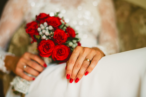 Bridal red roses bouquet in hands