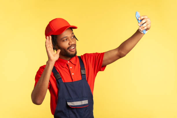 istock Workman having video call with client, waving hand, saying hello, being ready to execute order. 1341255043