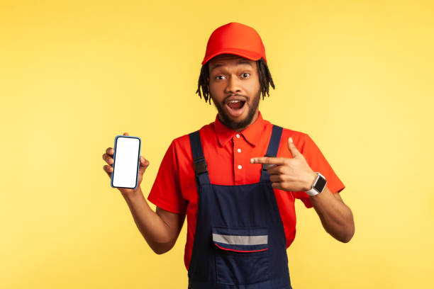 istock Workman pointing at mobile phone with blank screen, online delivery order app, maintenance services. 1341255054