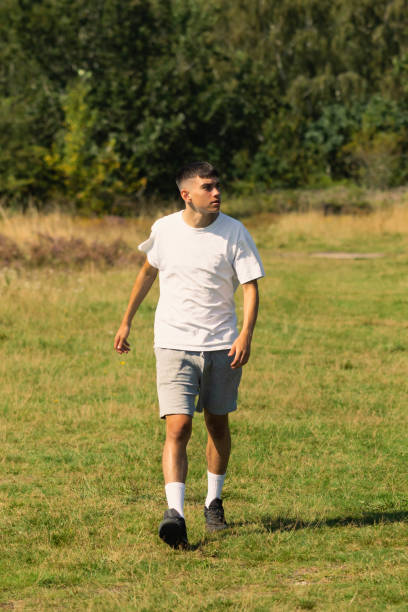 istock 18 year old walking outdoors on a summer day 1341256215