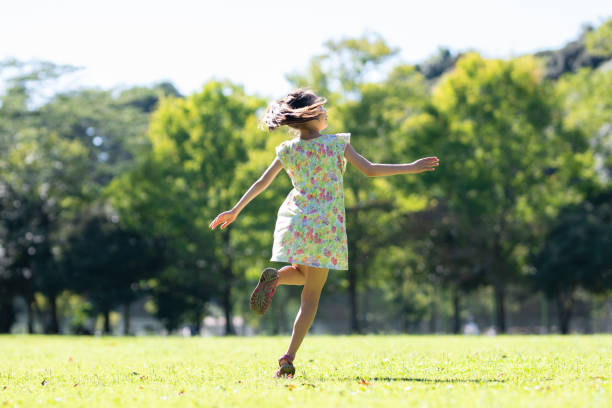 istock Girl dancing on the lawn 1341256320