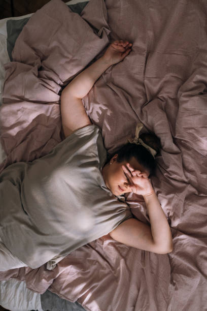istock Sound Asleep: Beautiful Plus Size Woman Sleeping on a Bed, From Above View 1341257559