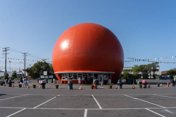 Gibeau Orange Julep restauant in Montreal, QC, Canada. Montreal, QC, Canada - September 4, 2021: Gibeau Orange Julep restauant in Montreal, QC, Canada. Gibeau Orange Julep is a fast food restauant with Iconic giant orange orb along the highway. named animal stock pictures, royalty-free photos & images