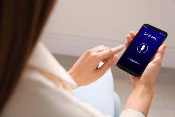 istock Woman using voice search on smartphone indoors, closeup 1341257695