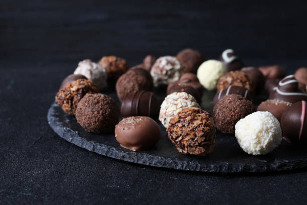 istock Different tasty chocolate candies on black table 1341259191
