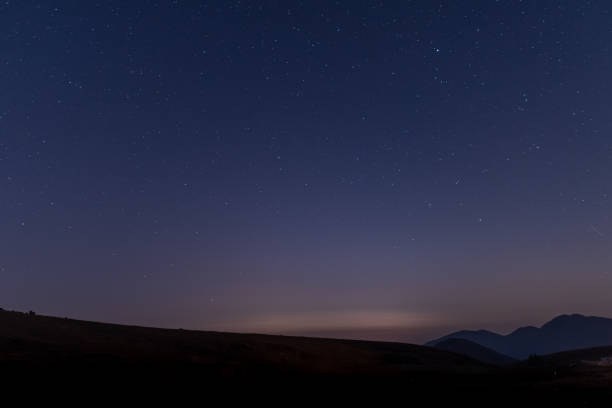 The starry sky at night on the grassland