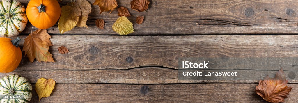 Autumn background with pumpkins and autumn leaves. Concept of Thanksgiving day or Halloween. Flat lay autumn composition with copy space Autumn background with pumpkins and autumn leaves. Concept of Thanksgiving day or Halloween. Flat lay autumn composition with copy space. Top view Thanksgiving - Holiday Stock Photo