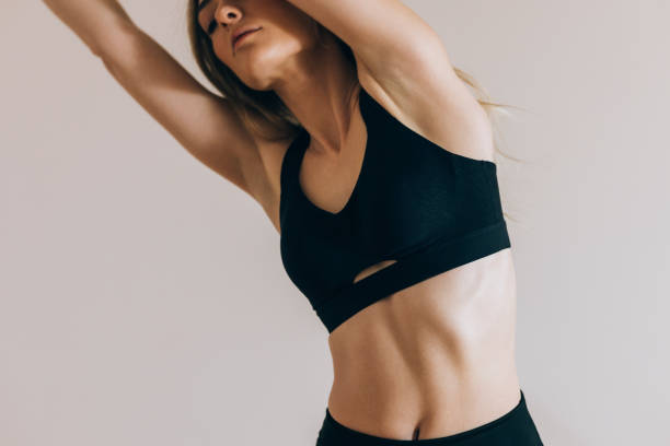 istock Beautiful Female Athlete Standing Doing Warm Up Exercises (Horizontal, Copy Space) 1341263913