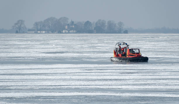A sailing boat moored in a frozen basin during a cold winter.