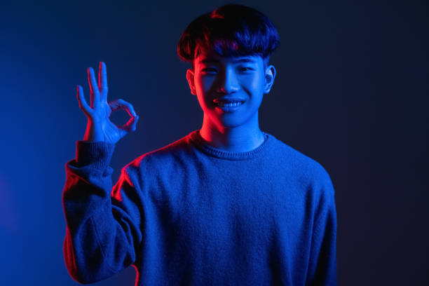 istock okay gesture approval sign man blue neon light 1341266393