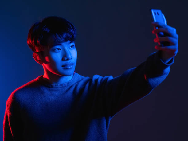 istock neon light selfie futuristic technology man phone 1341266402