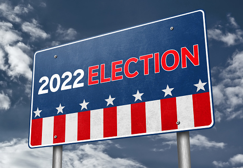 2022 Election message written over dark blue background below rippled American flag. Vertical composition with copy space. Front view. 2022 US Midterm Elections Concept.