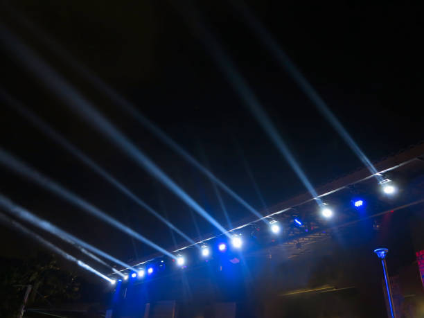 istock Spotlights on stage with smoke and blue lights 1341272539