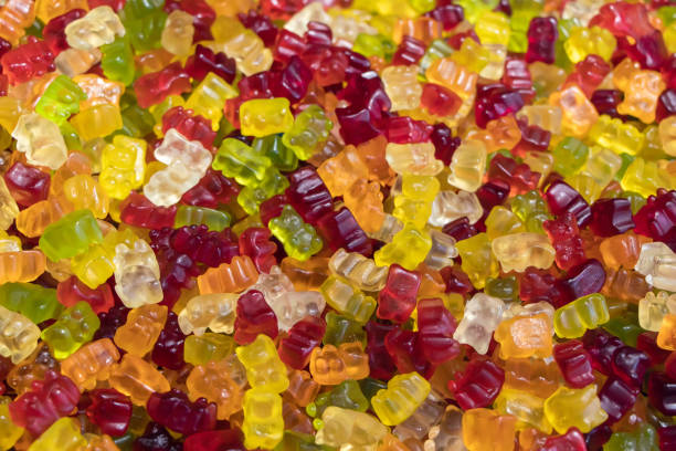 istock Multicolored jelly stick candies textured background 1341274259