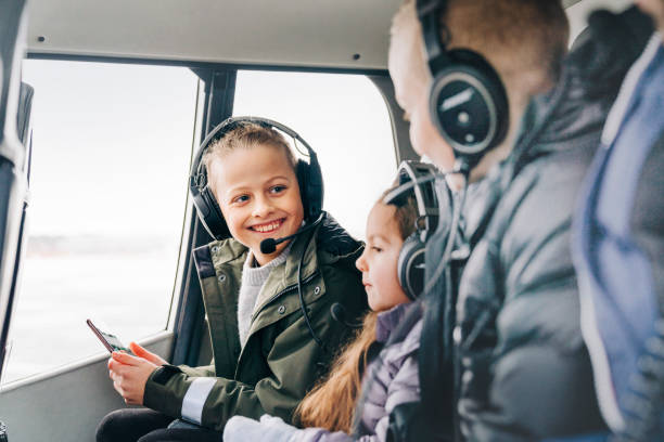 istock Smiling young boy with family on a helicopter ride 1341275409