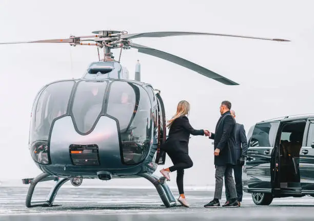 Photo of Wealthy couple traveling by a private helicopter