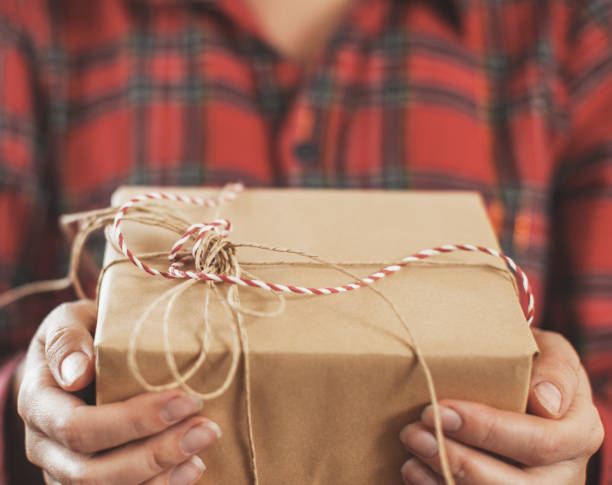 istock Christmas gift on female hands 1341280874