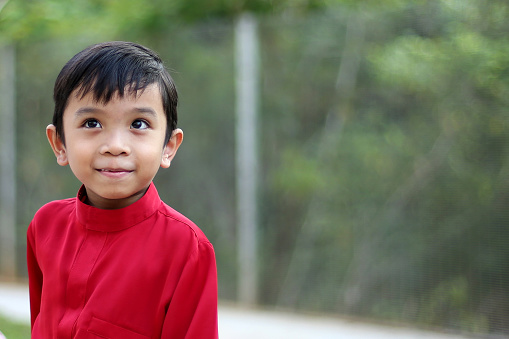 Portrait of Muslim boy at playground.