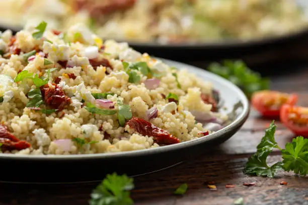 Couscous salad with sun dried tomatoes, cucumber, red onion and feta cheese. healthy food