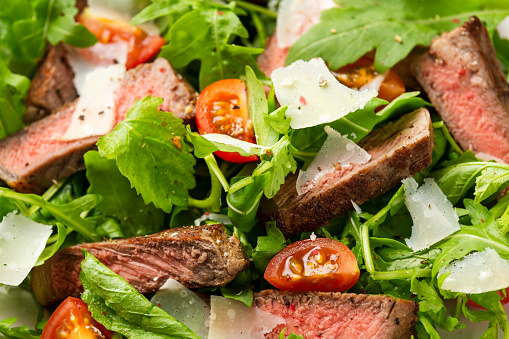 Italian Beef Tagliata salad with wild rocket, cherry tomatoes and parmesan cheese.
