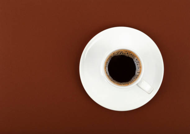 istock Full white espresso coffee cup over brown 1341282074
