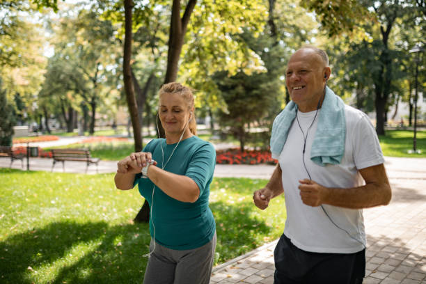 istock Mature couple jogging in public park 1341282449