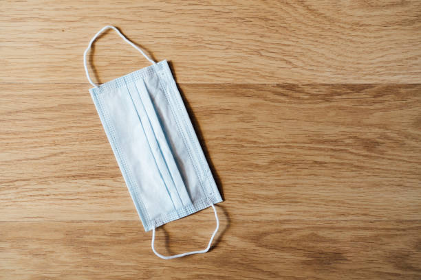istock medical protective mask on wooden floor 1341284999