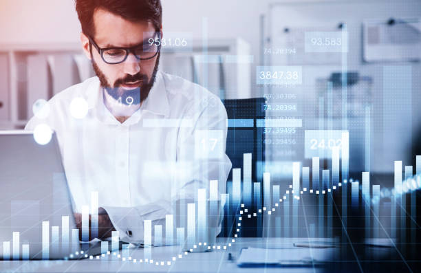 istock Businessman is analyzing stock market behavior via laptop 1341285011