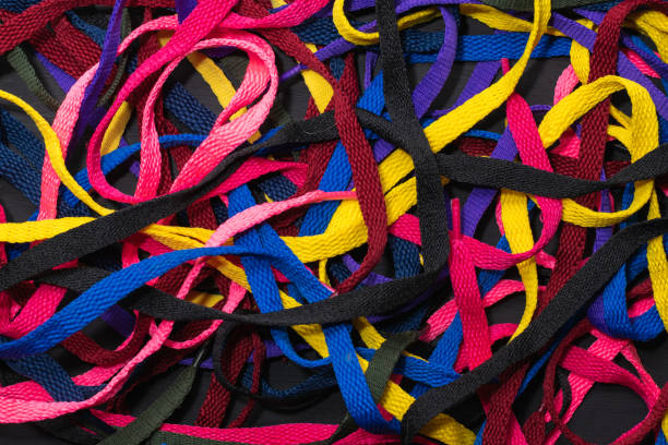 istock colorful shoelaces background, on black wood, messy, clutter concept, advertisement 1341285692