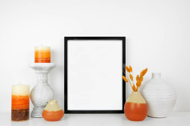 istock Mock up black frame with autumn home decor on a white shelf 1341286924