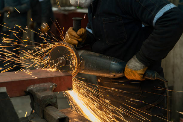 istock Worker man working with electric grinder tool on steel structure in factory. 1341289239