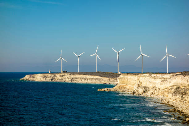 istock Rocky seashore and Wind turbines 1341289390