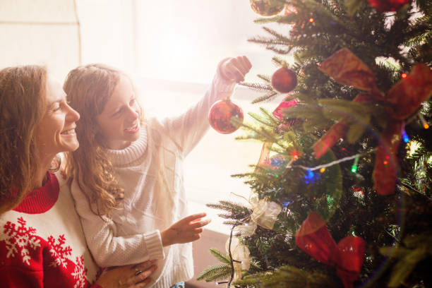 istock Mom and daughter decorate the Christmas tree 1341289687