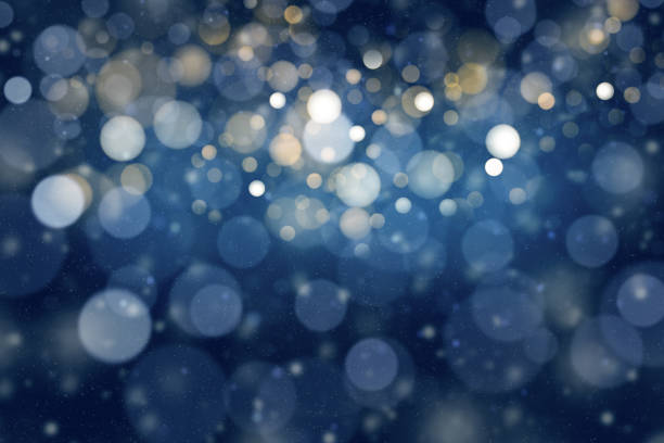 Photo of Bokeh lights dark blue holiday background.