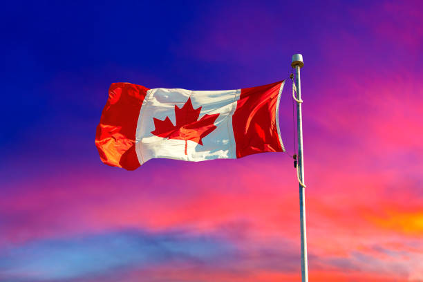 istock Canadian flag against blue sky 1341293013