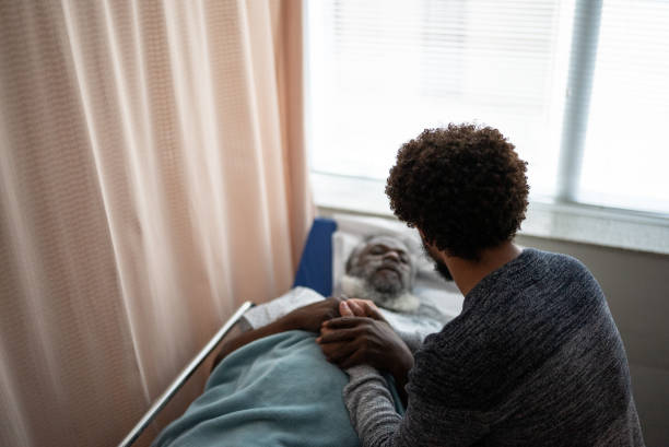 istock Young man visiting hospitalized father 1341294463