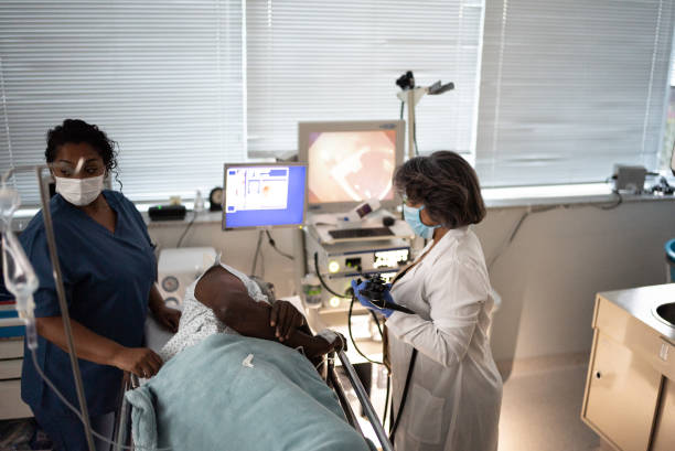istock Doctor examining patient with endoscope 1341294577